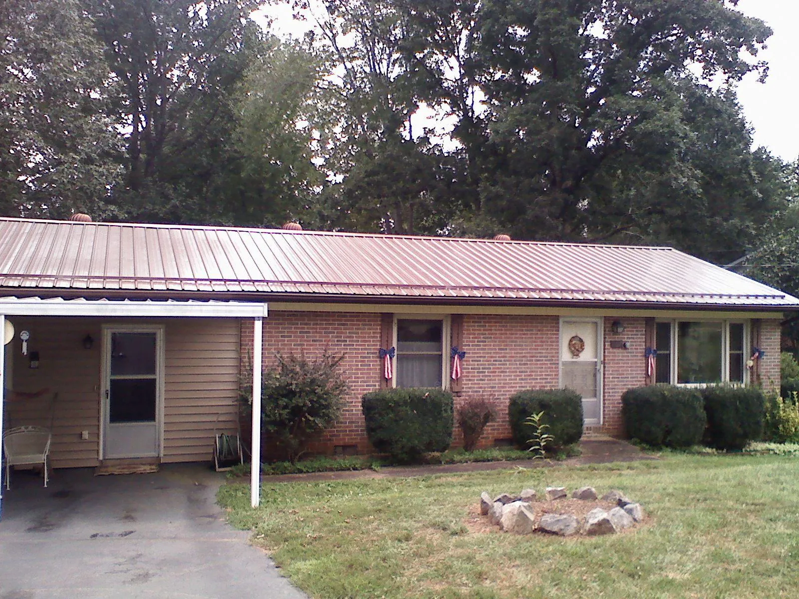 Bronze metal roof and carport on a brick ranch home — Roof Repair work by our crew in Yorkshire